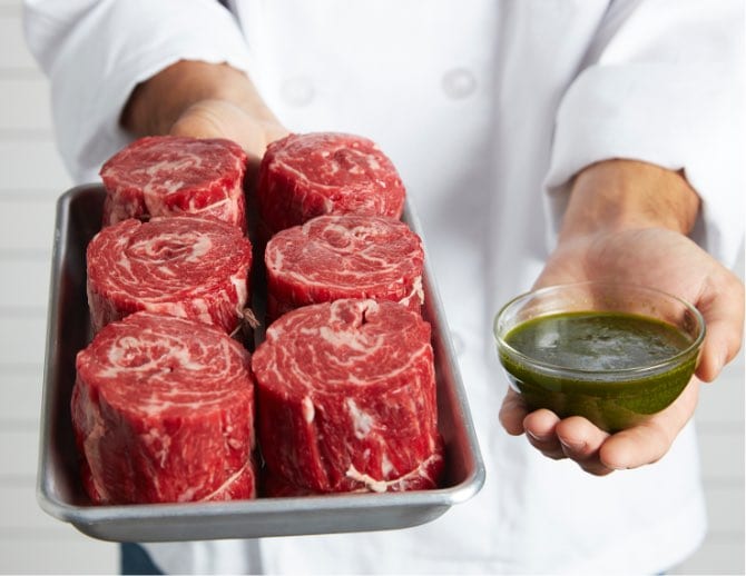 lady-holding-meat Foodservice Beef Cuts